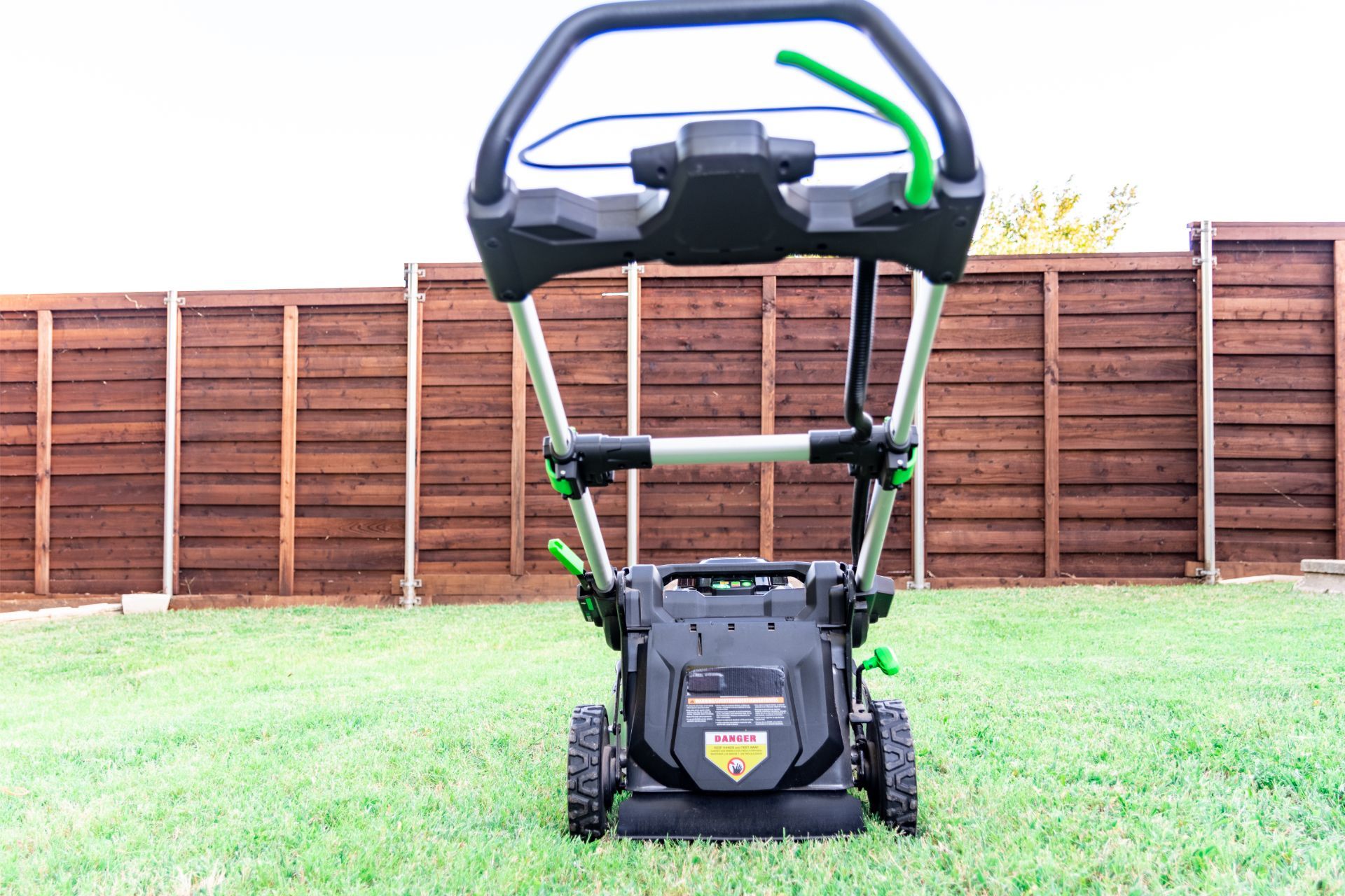 Athens, GA, yard with a battery-powered lawn mower.