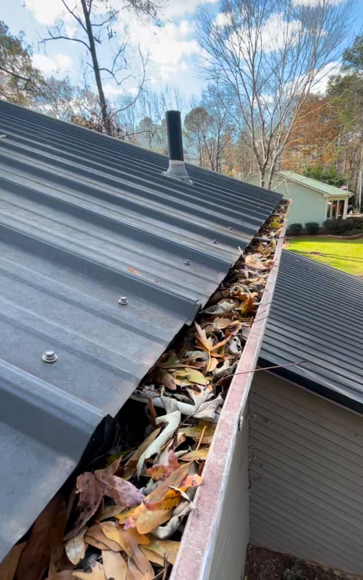 Removing debris from gutters to ensure proper drainage and home safety.