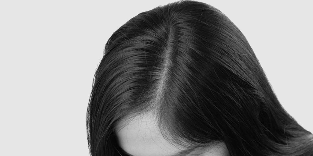 It is a black and white photo of a woman 's hair.