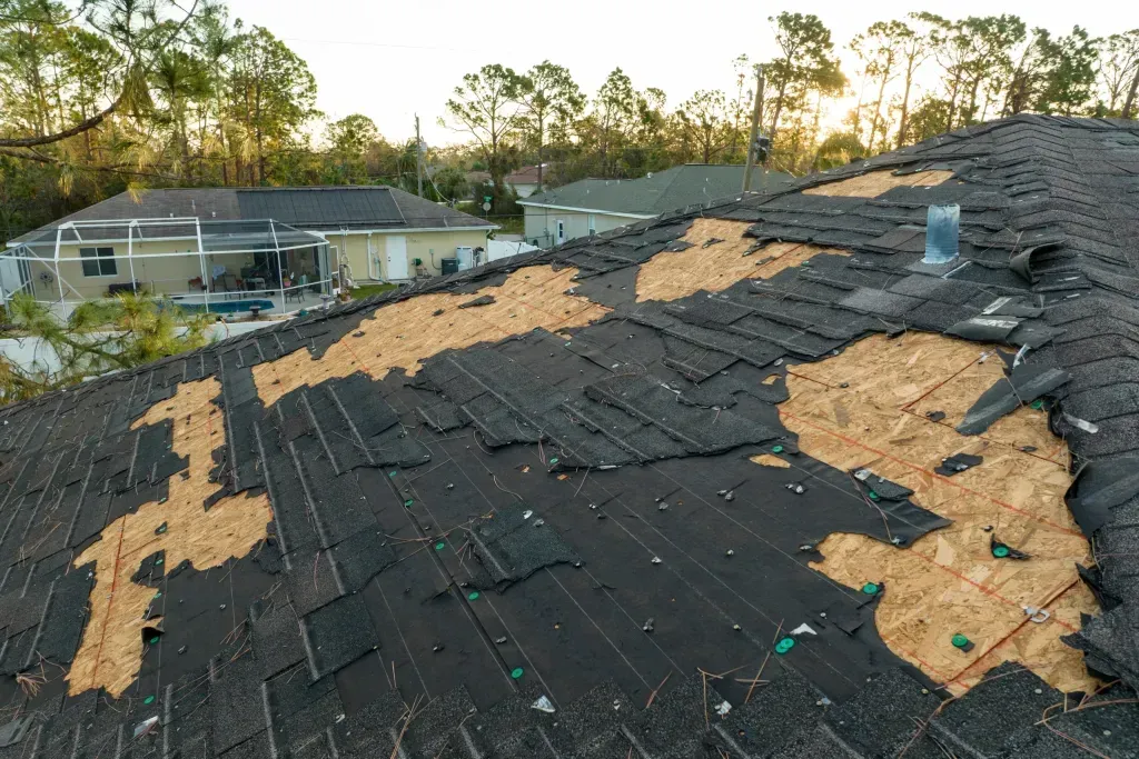 The roof of a house has been damaged by a storm.