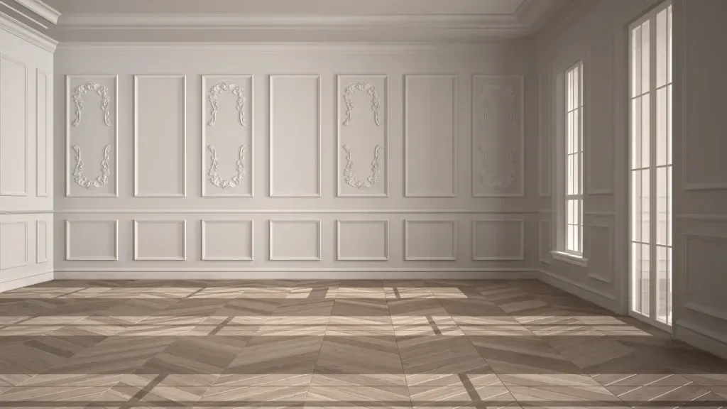 An empty room with white walls and a wooden floor.
