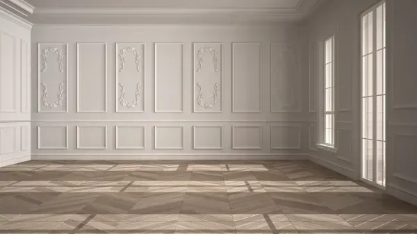 An empty room with white walls and a wooden floor.