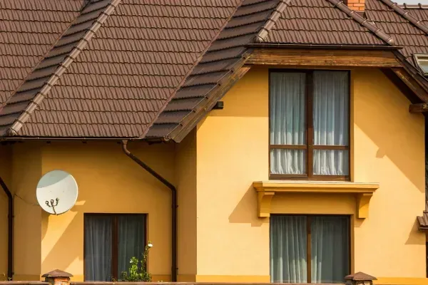 A house with a satellite dish on the side of it