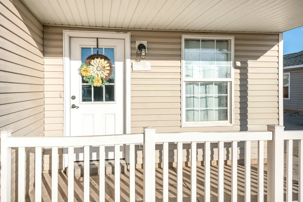 A house with a white door and a white railing