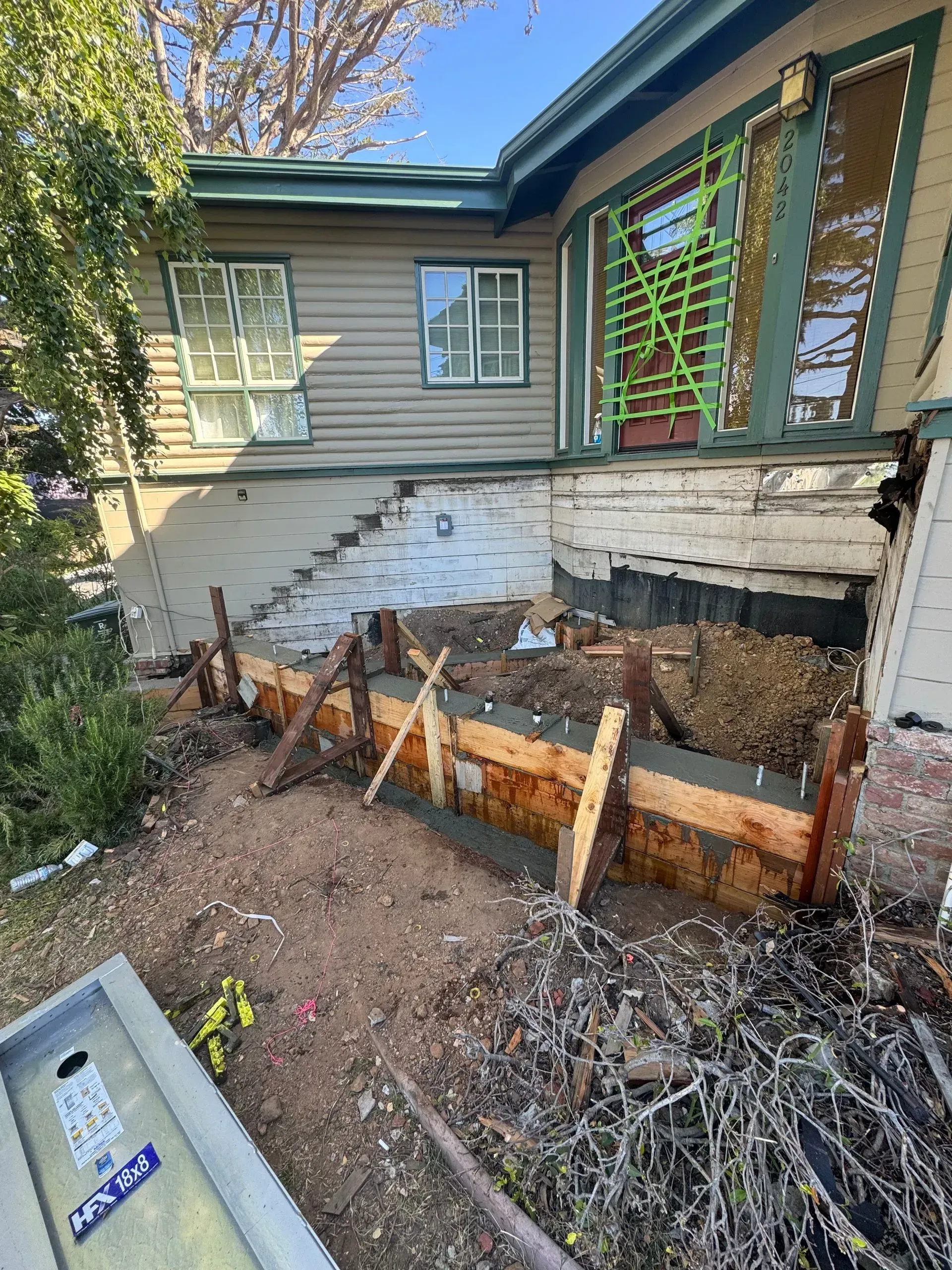 A house is being demolished and a kayak is sitting in front of it.