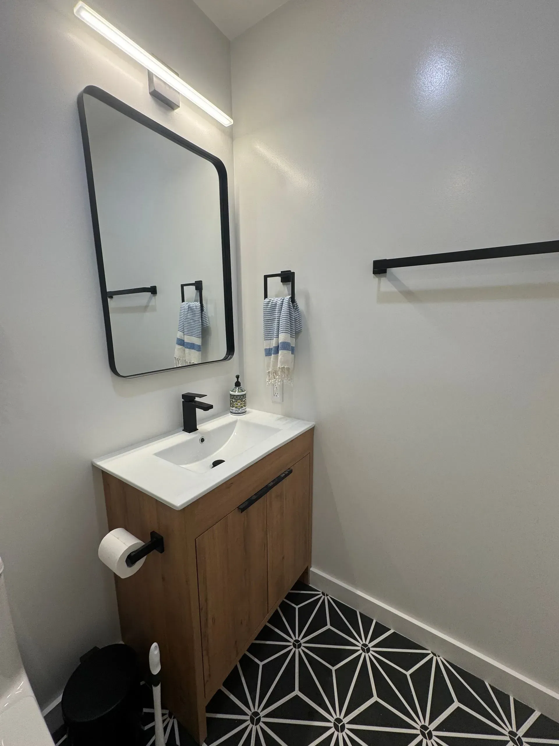 A bathroom with a sink , mirror and toilet.