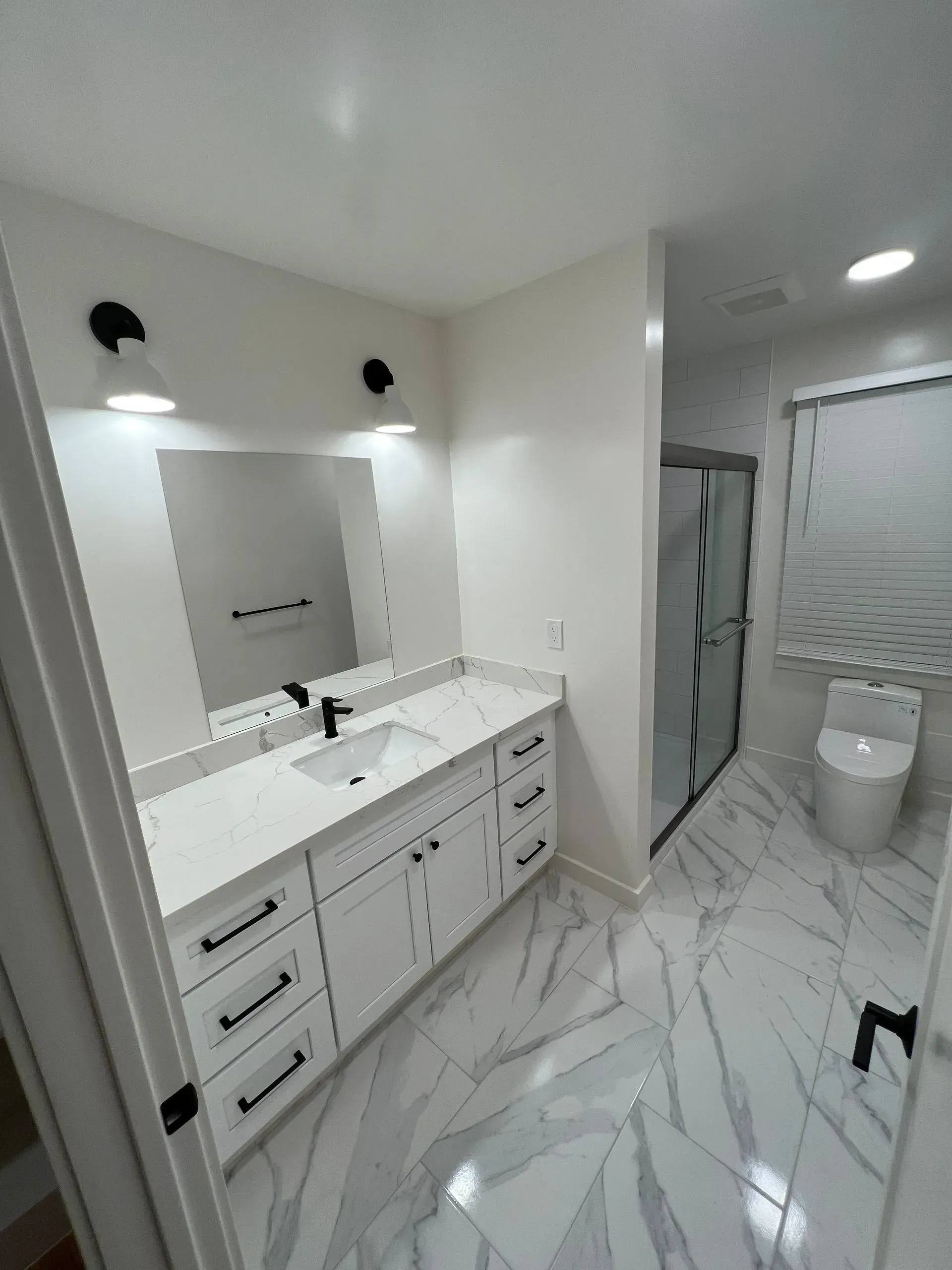 A bathroom with a sink , toilet , and mirror.