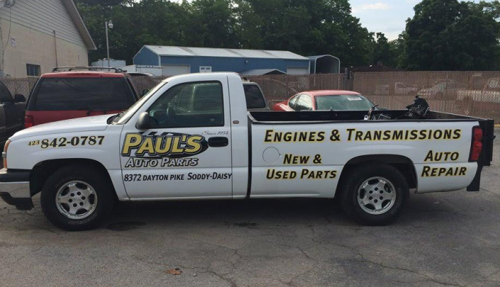 White pickup truck with business logo 