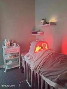 A bed in a room with a red light on it