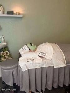 A woman is laying on a bed with a mask on her face