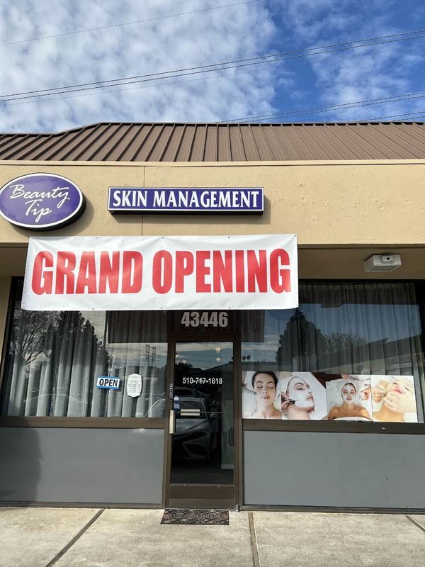 A store front with a sign that says grand opening