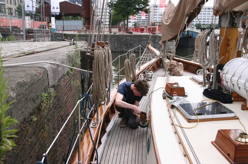 A man is working on the deck of a boat