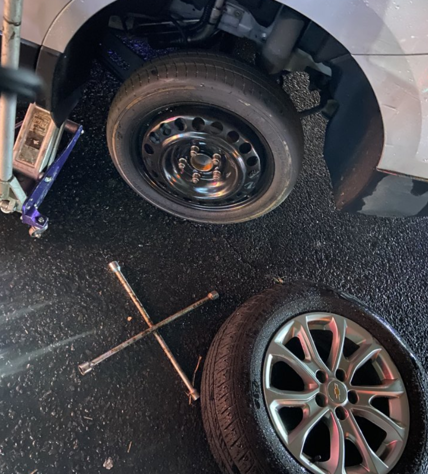 Tire change in a parking lot.