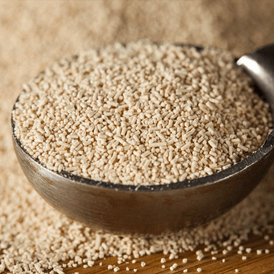 Dry granulated yeast in an overflowing bowl