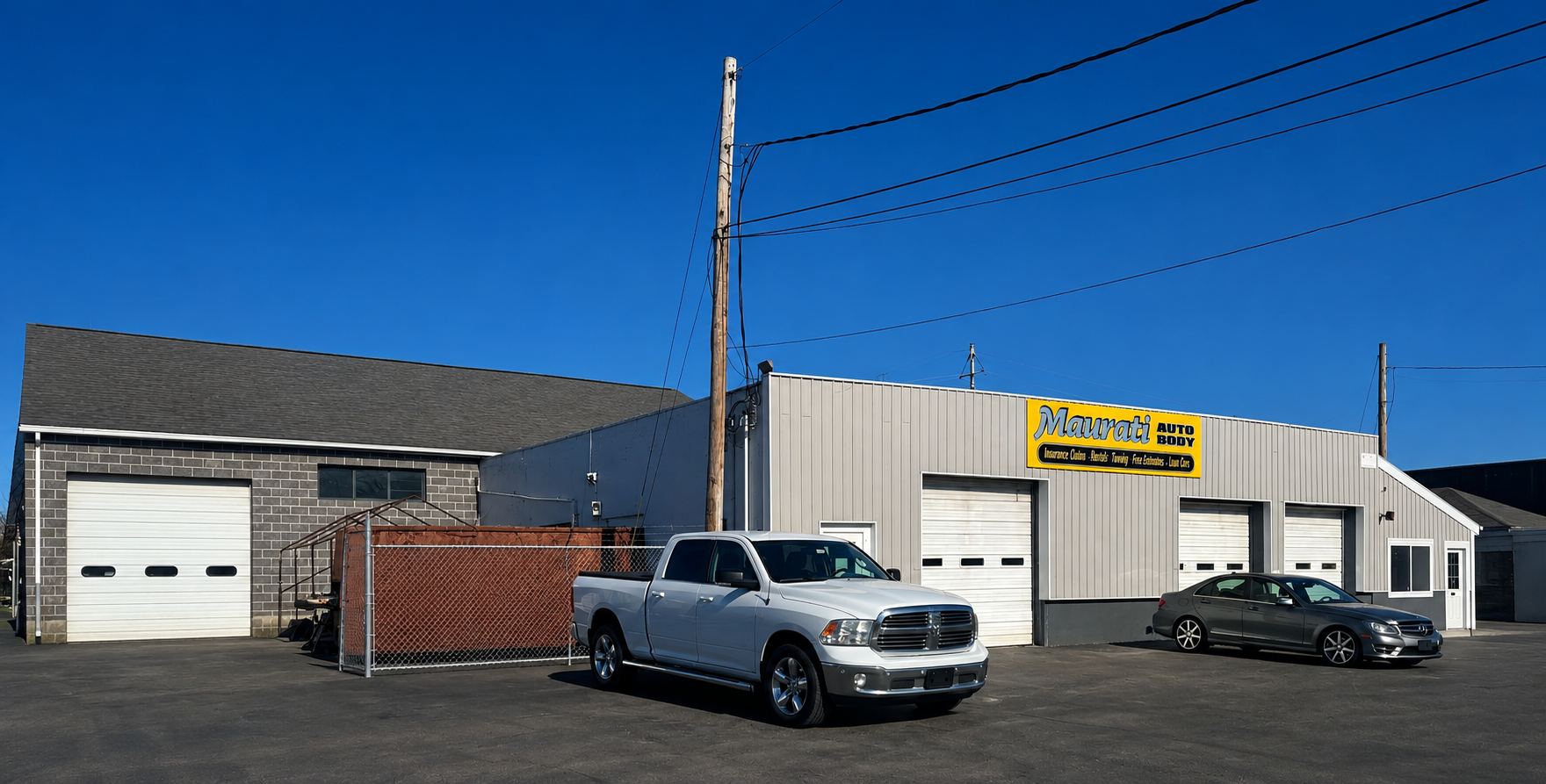 Aerial view of Maurati Auto Body, with cars parked outside a building.