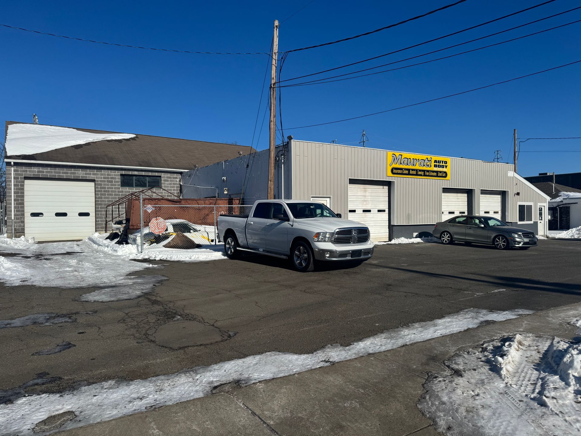 Aerial view of Maurati Auto Body, with cars parked outside a building.