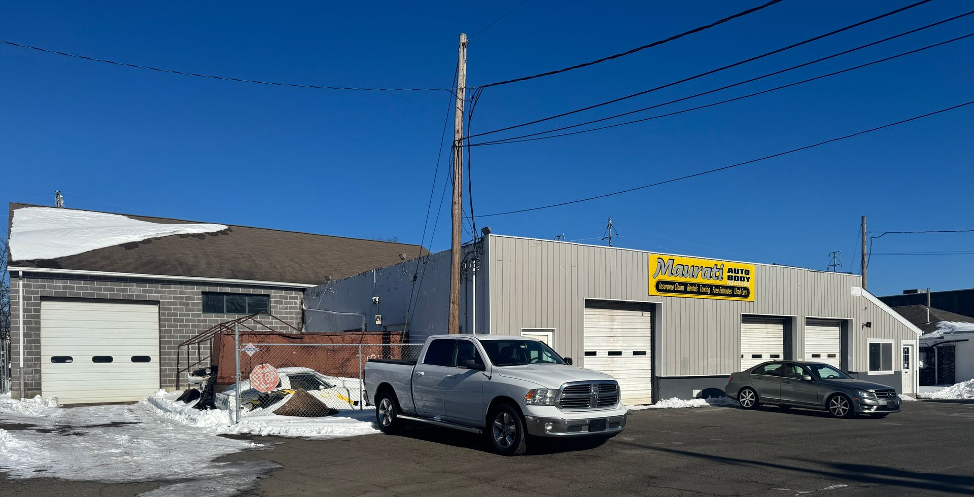Aerial view of Maurati Auto Body, with cars parked outside a building.