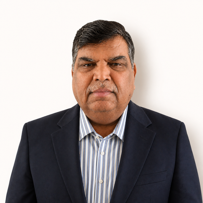 Head-and-shoulders portrait of a man in a dark blazer and striped shirt against a white background