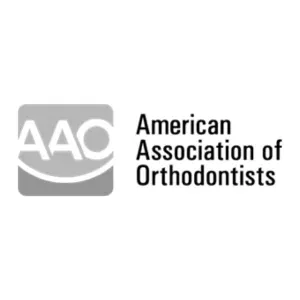 the logo for the american association of orthodontists is black and white .