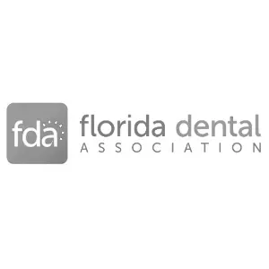 the logo for the florida dental association is black and white .