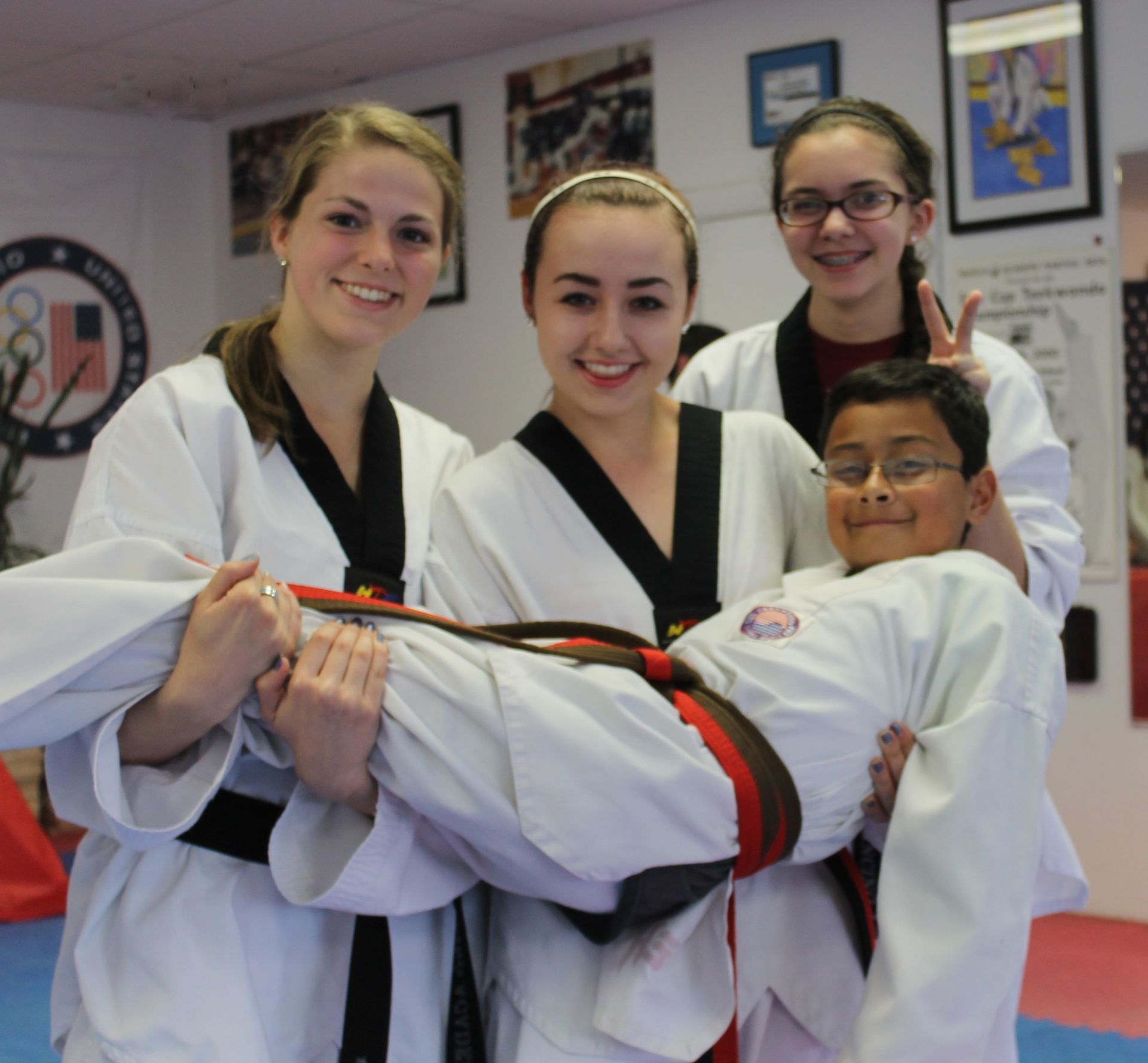 A group of karate students are posing for a picture. Mancino Academy Martial Arts