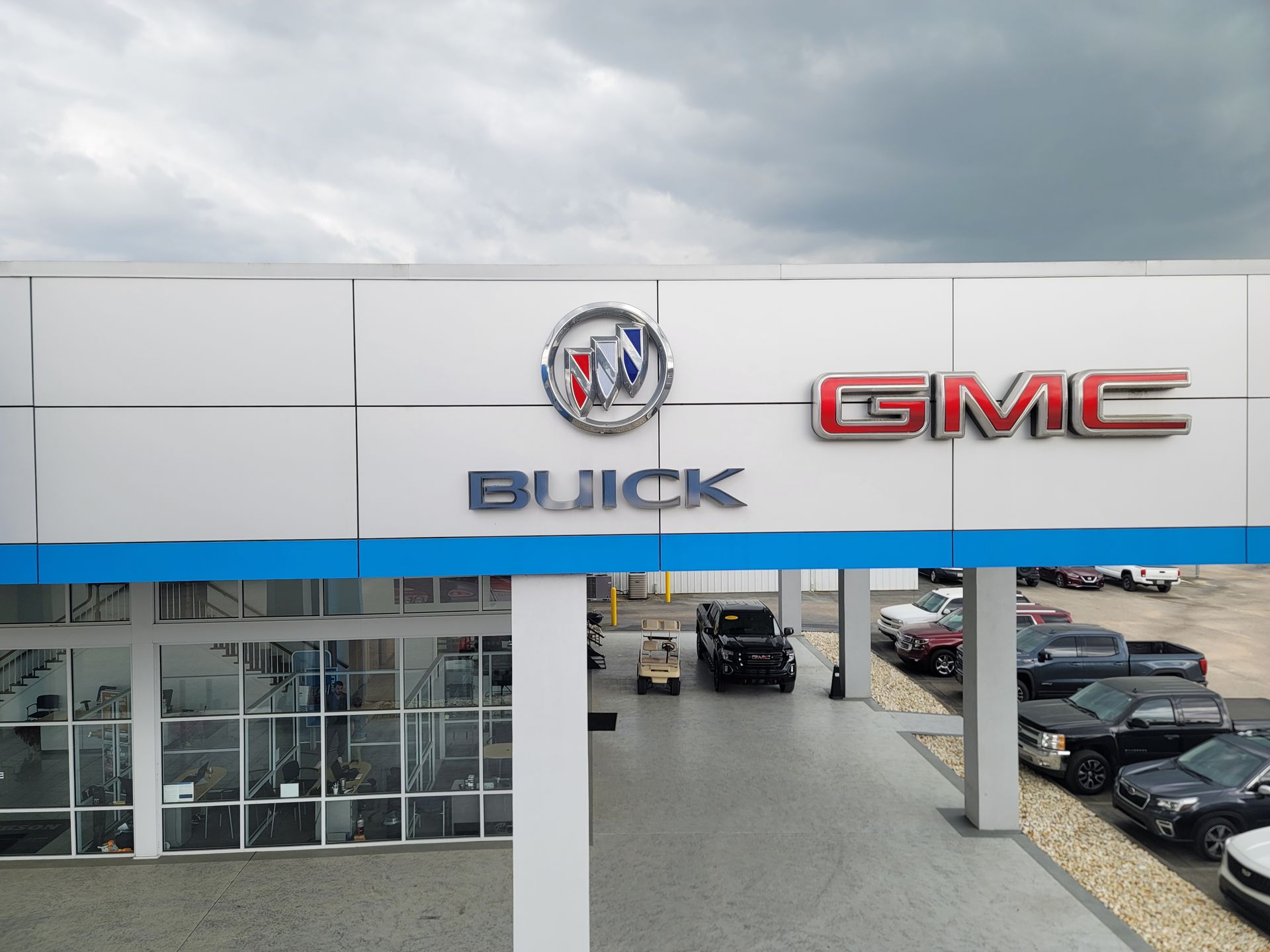 A buick and gmc dealership with cars parked outside