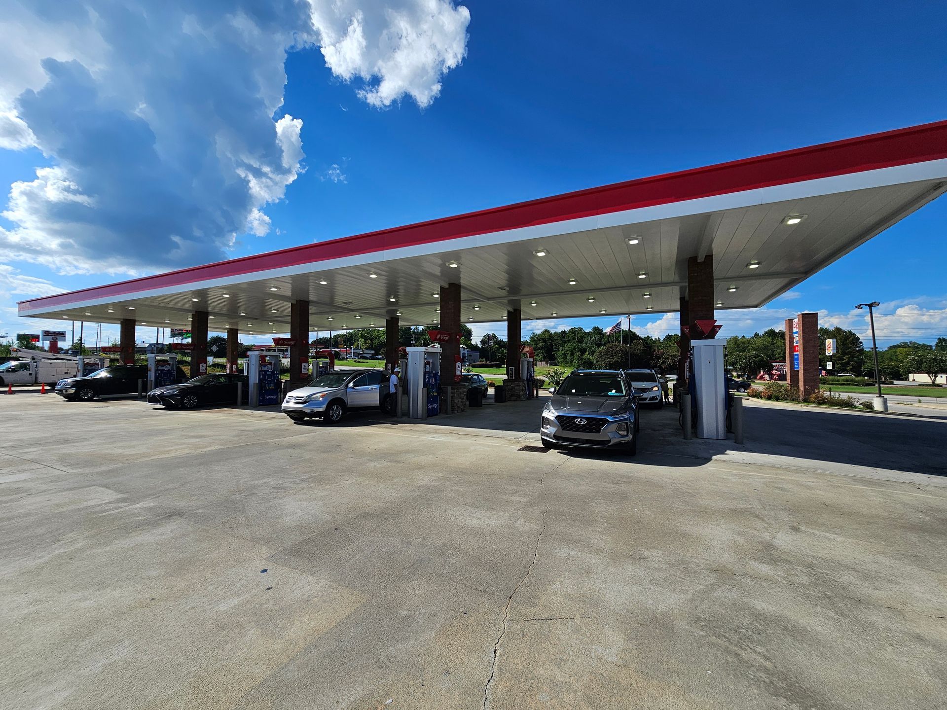 A gas station with cars parked in front of it