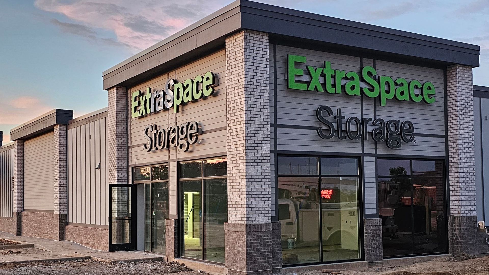 A large building with a lot of windows and a sign that says extra space storage.