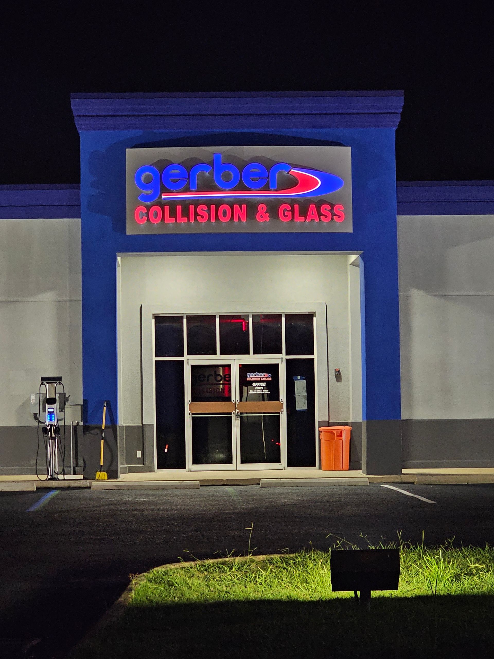 A gerber 's collision and glass store is lit up at night