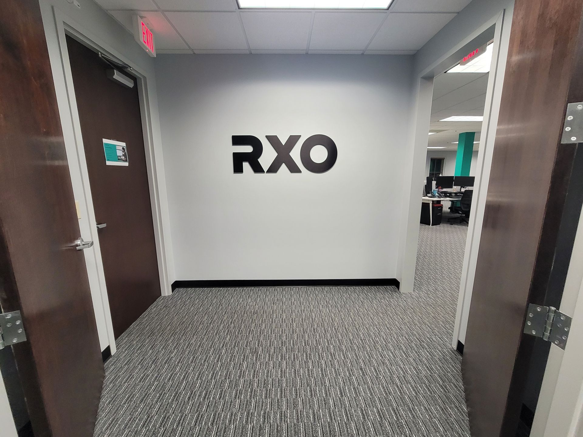 A hallway with a sign on the wall that says rxo