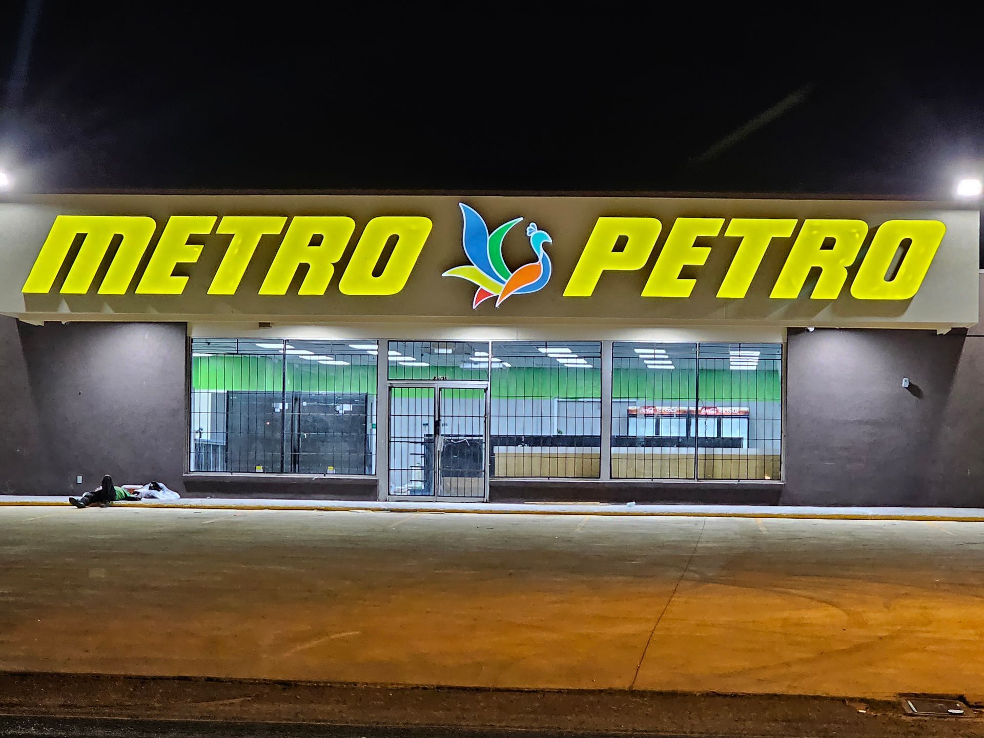 A metro petro store is lit up at night