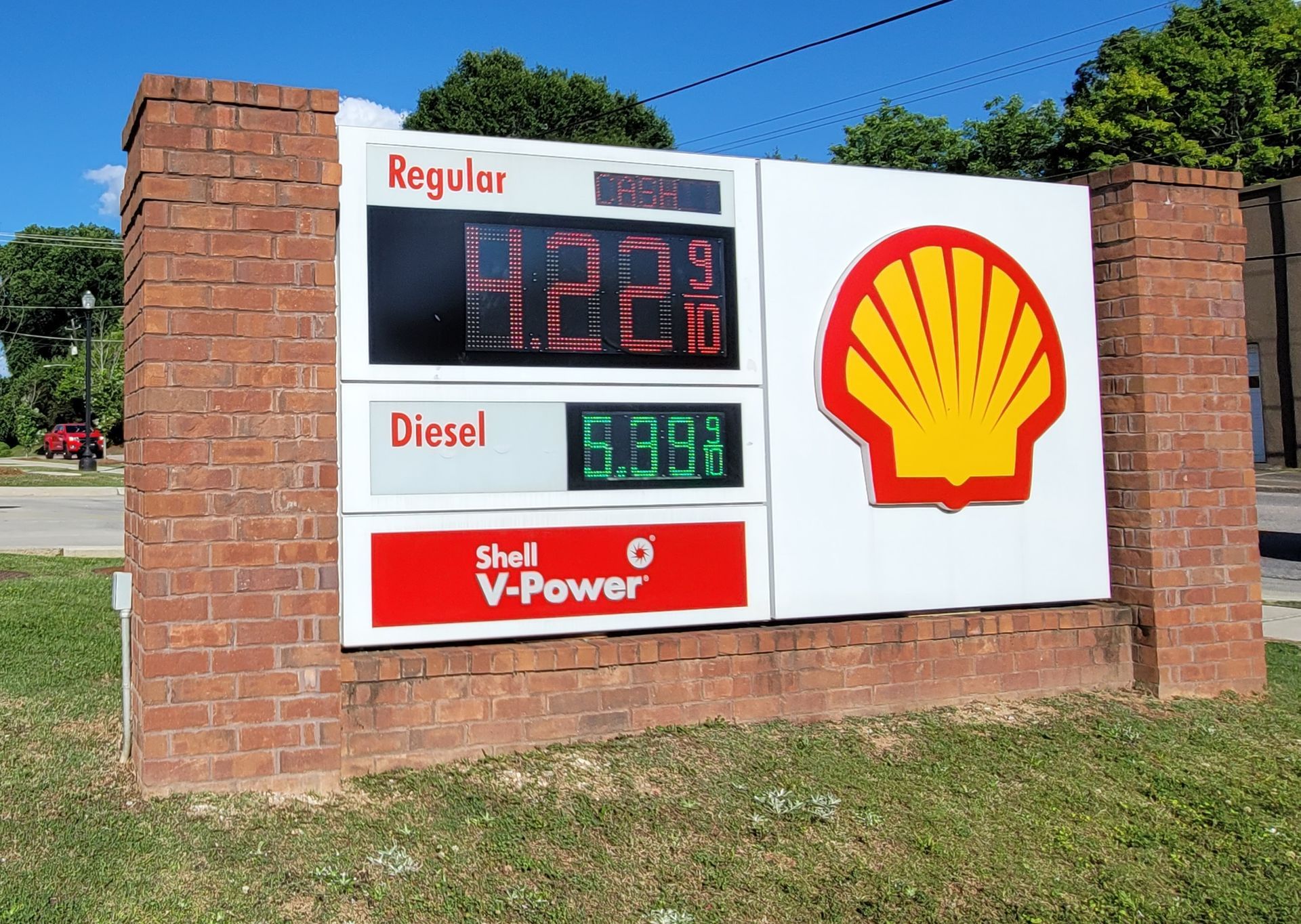 A shell gas station has a sign that says regular diesel and v-power