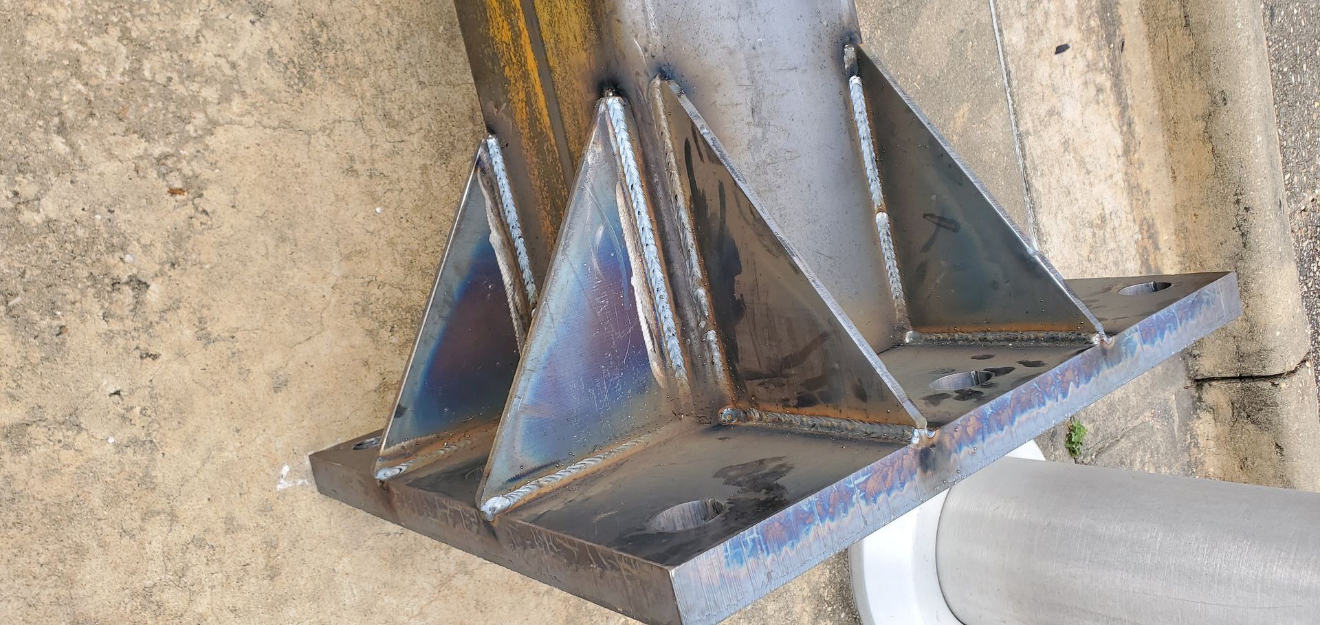 A metal bracket is attached to a concrete wall.