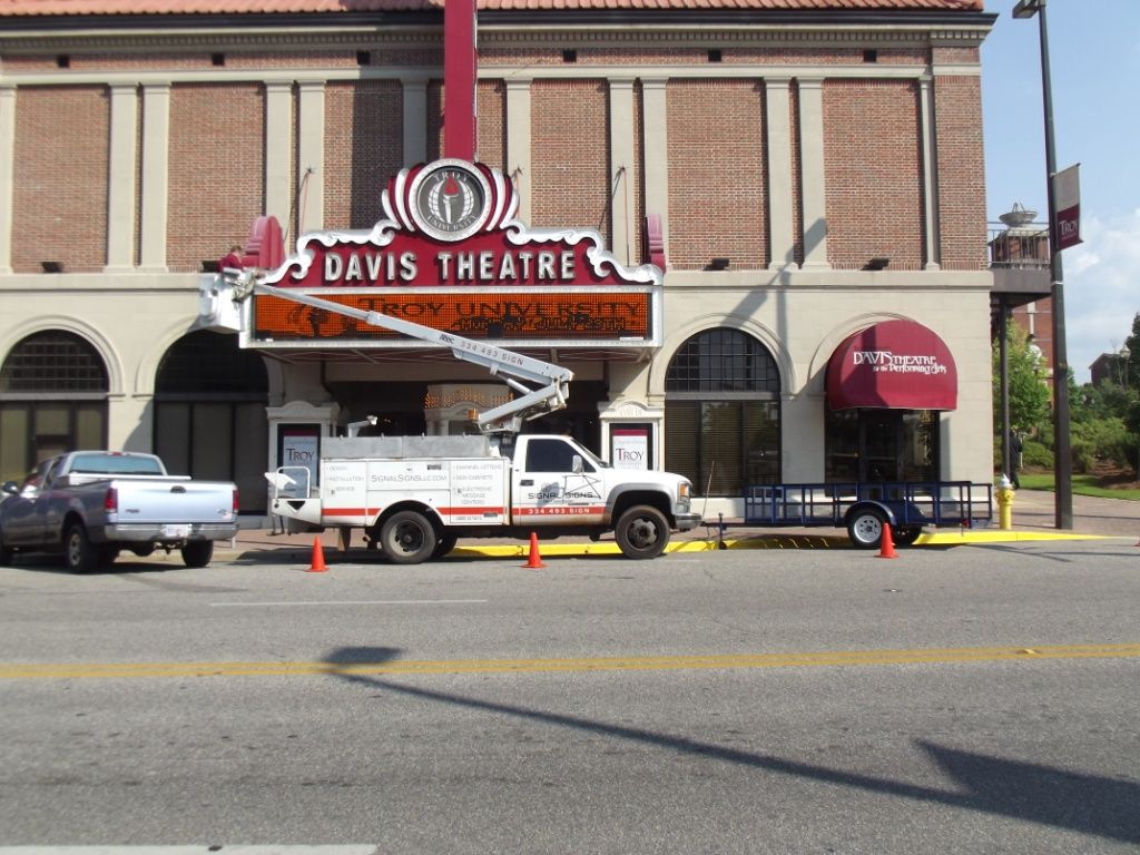A truck is parked in front of the davis theatre