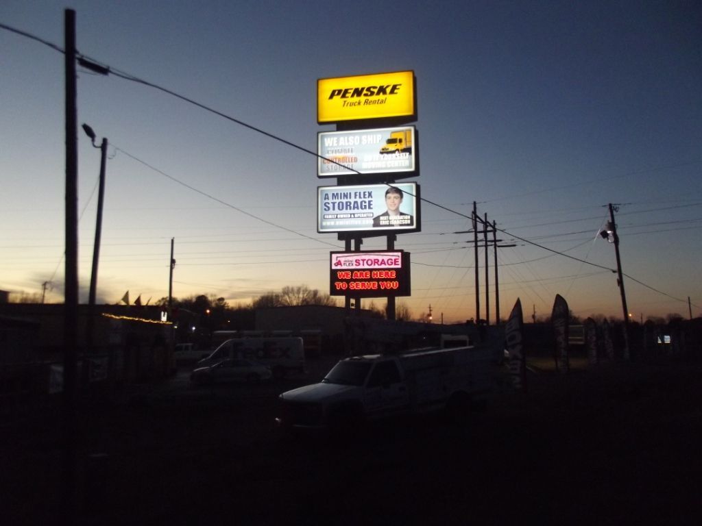 A sunset with a pensky sign in the foreground