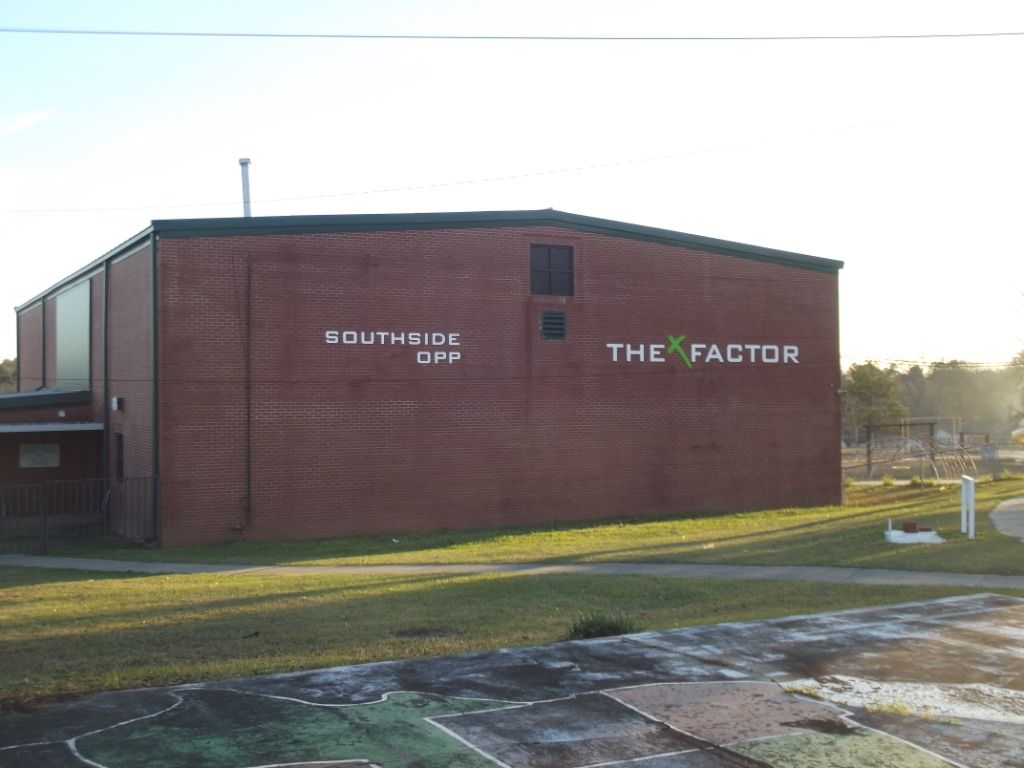 A large brick building with the word the factor on the side