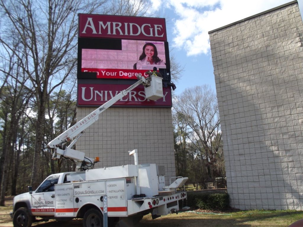 A sign for amridge university is being installed