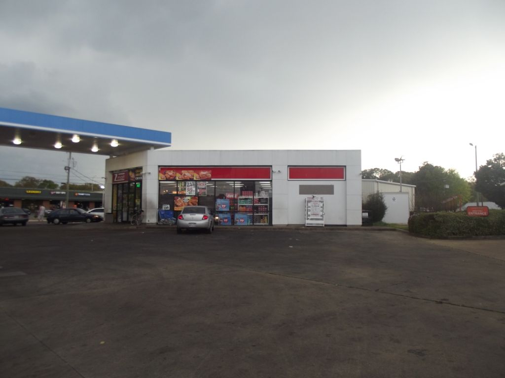 A car is parked in front of a gas station