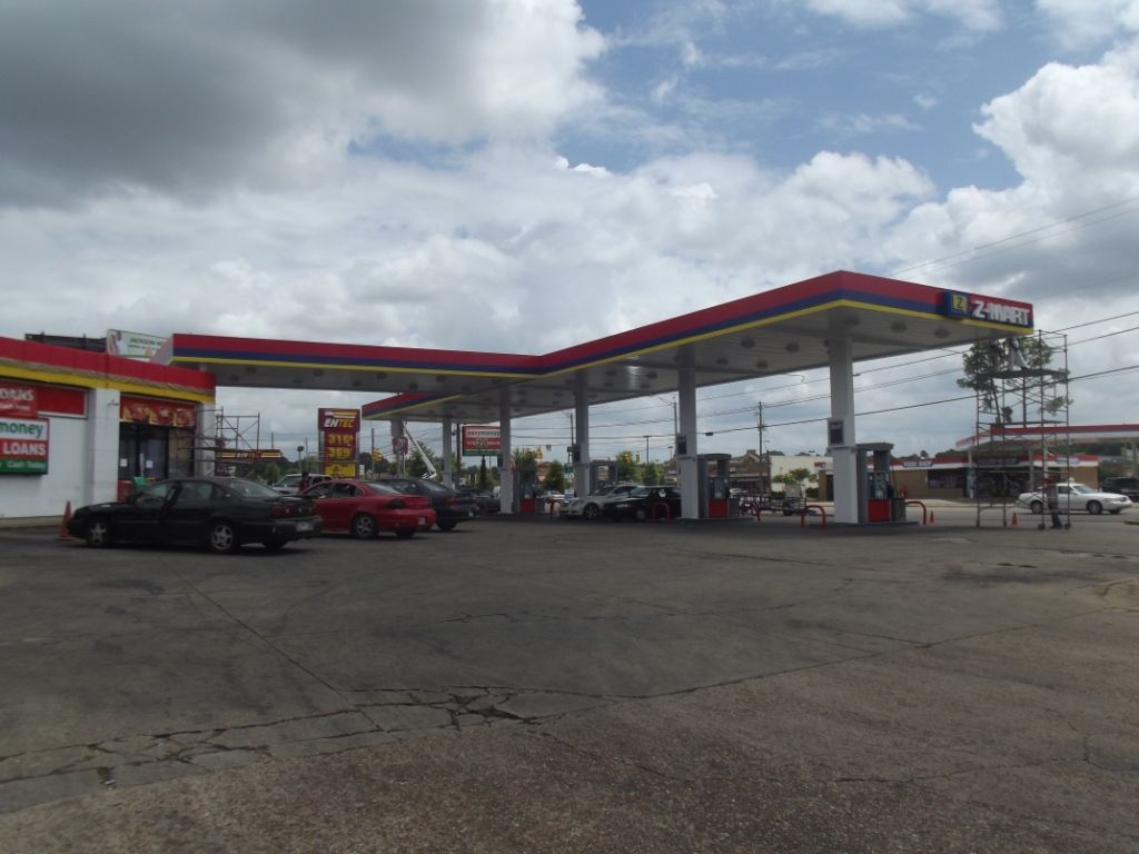 A gas station with cars parked in front of it