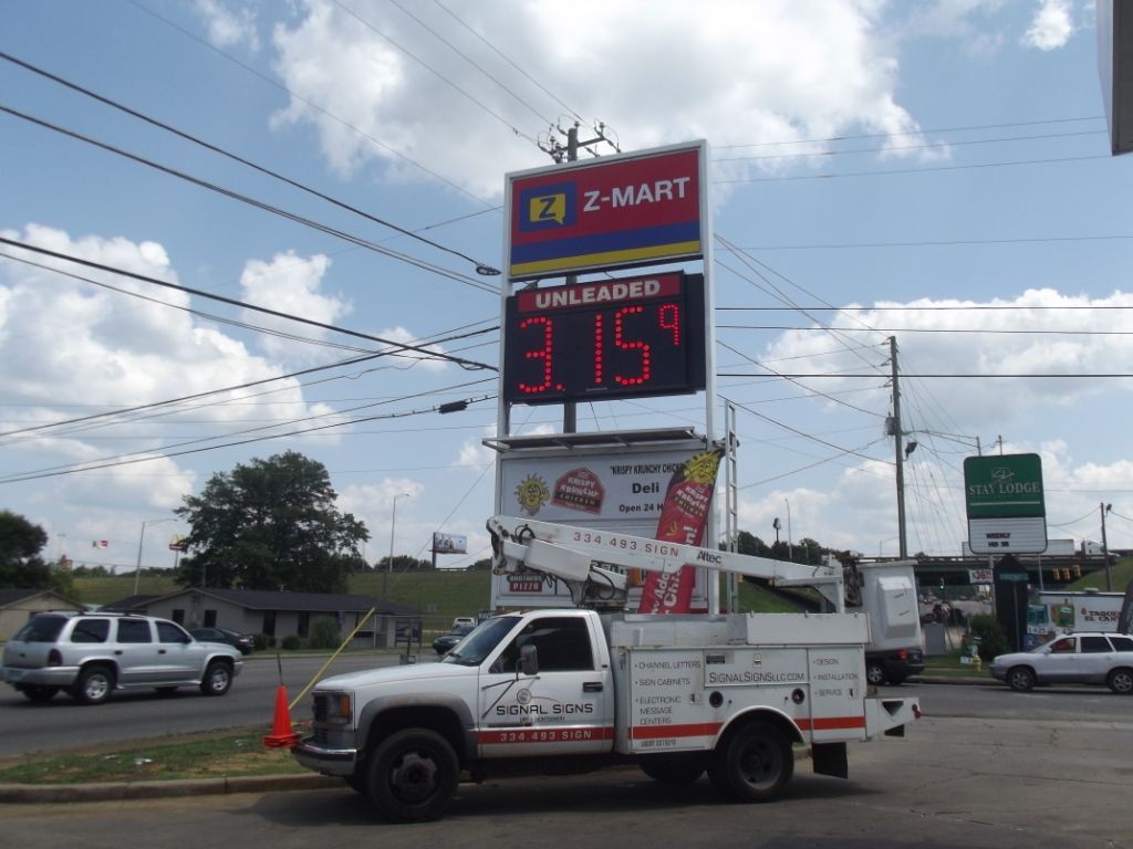 A truck is parked in front of a sign that says 3.15