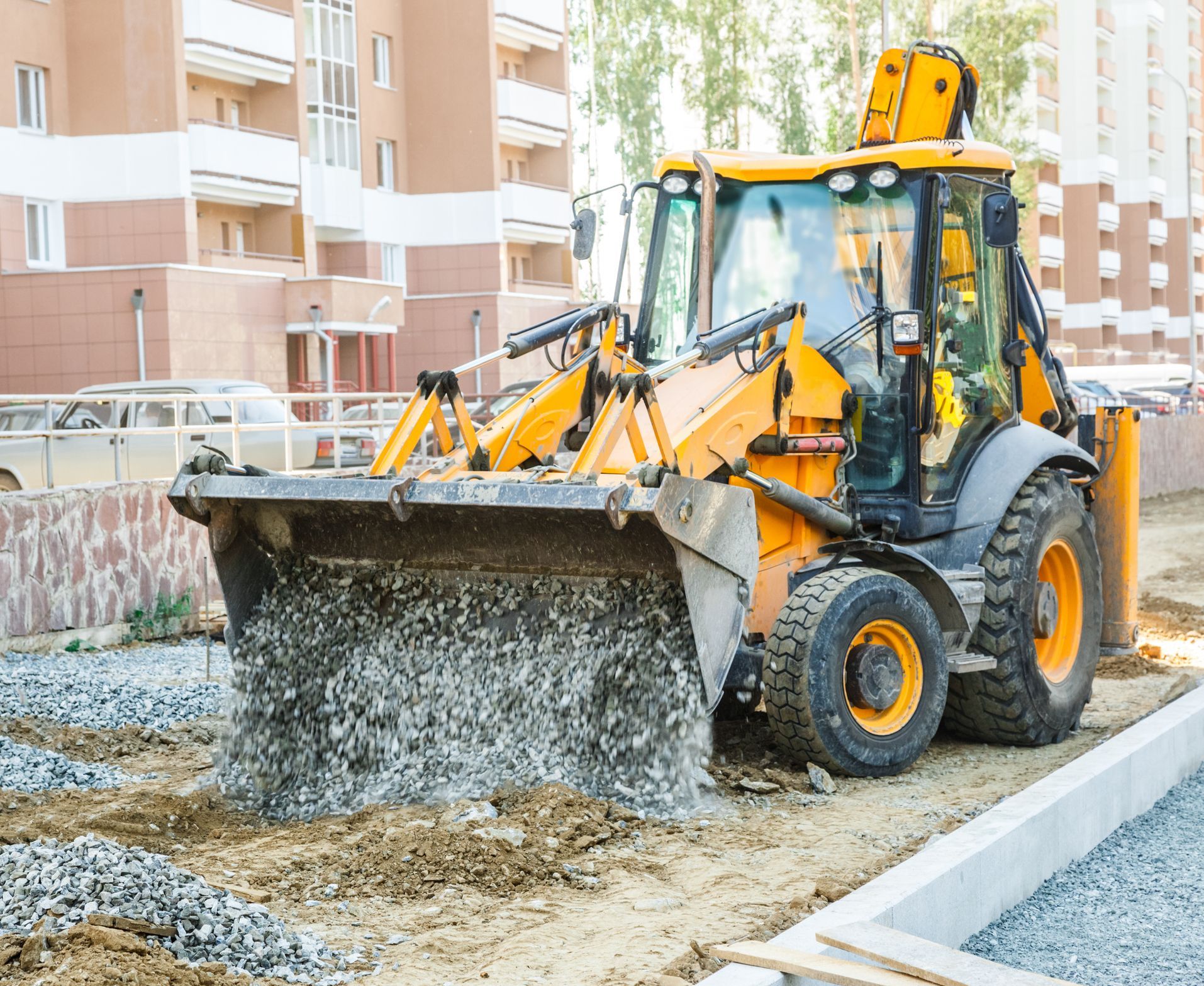 A yellow bulldozer is moving dirt on a construction site.