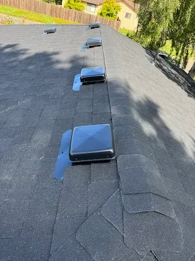 Black roof with evenly spaced, square roof vents.