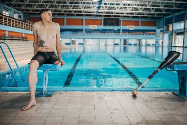 A disabled man needing support at the swimming pool