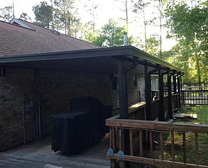 Brown House With Carport Cover— New Orleans, LA — Mike's Patio Covers & Screenrooms