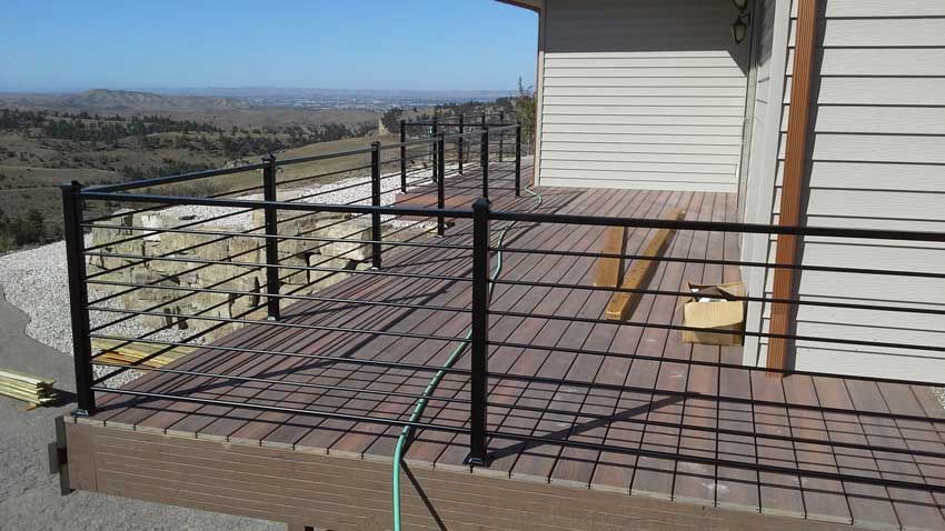 A deck with a fence and a hose on it