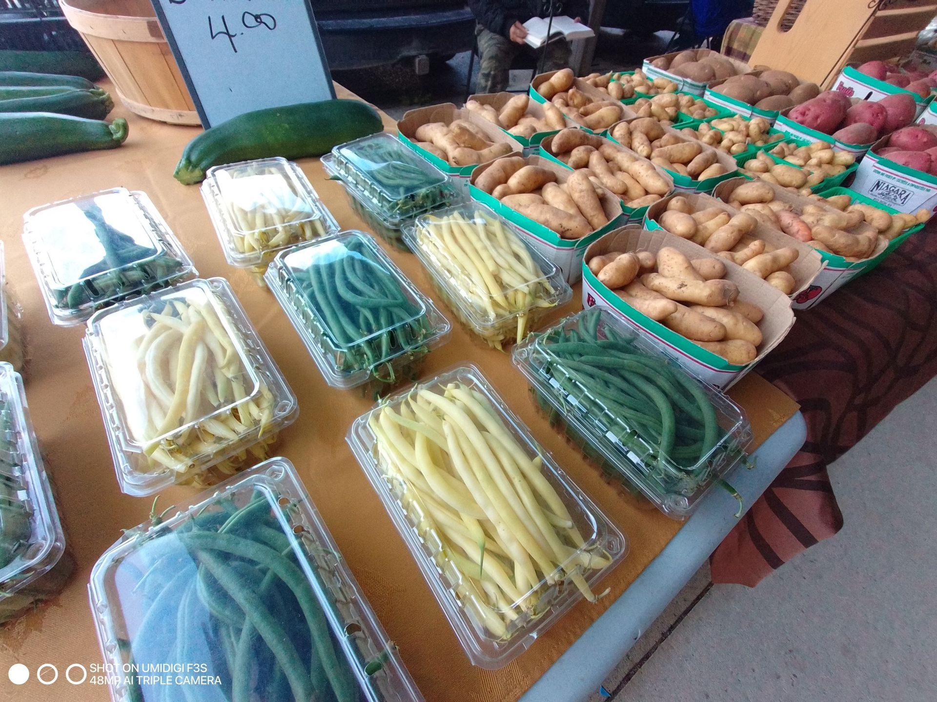 Vegetables and potatoes in a stand.