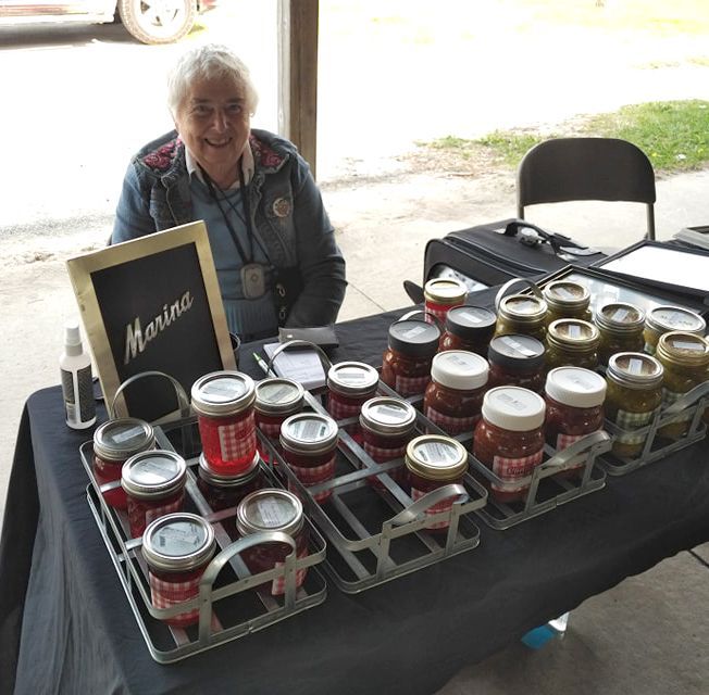 Marina sitting at a table with her jams.