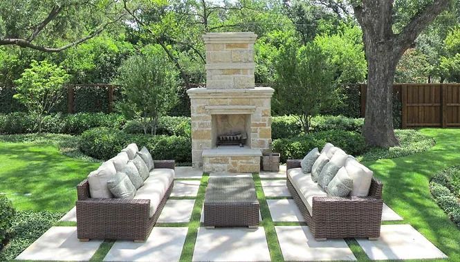 There is a fireplace in the middle of the backyard.