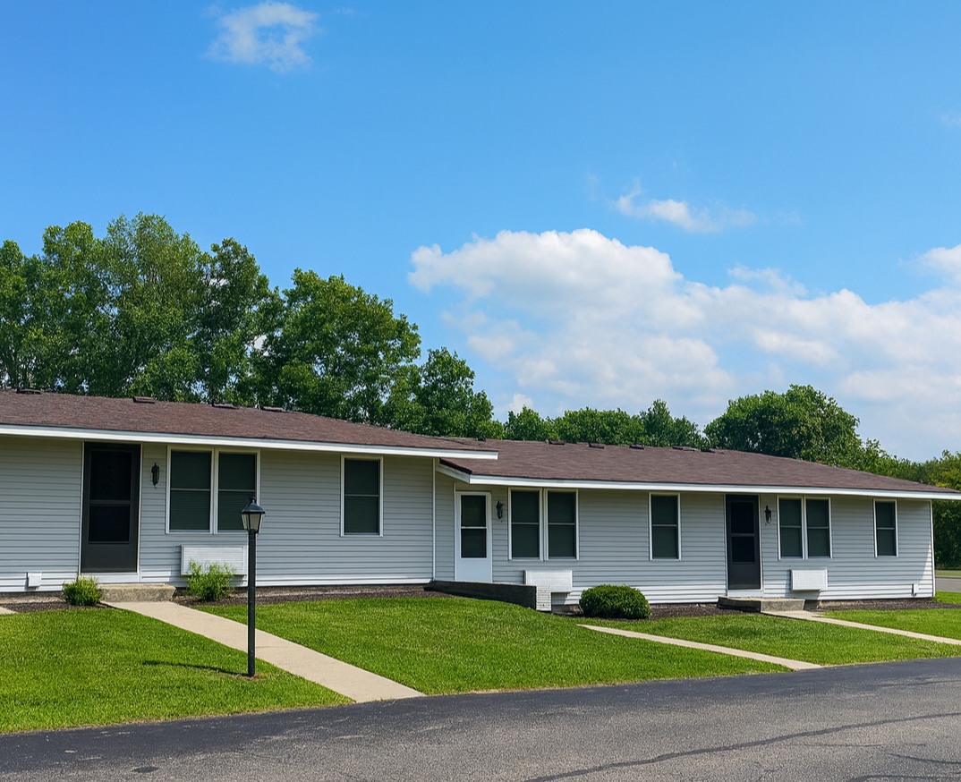 Photo of an apartment community with the entrances to three units seen in the photo