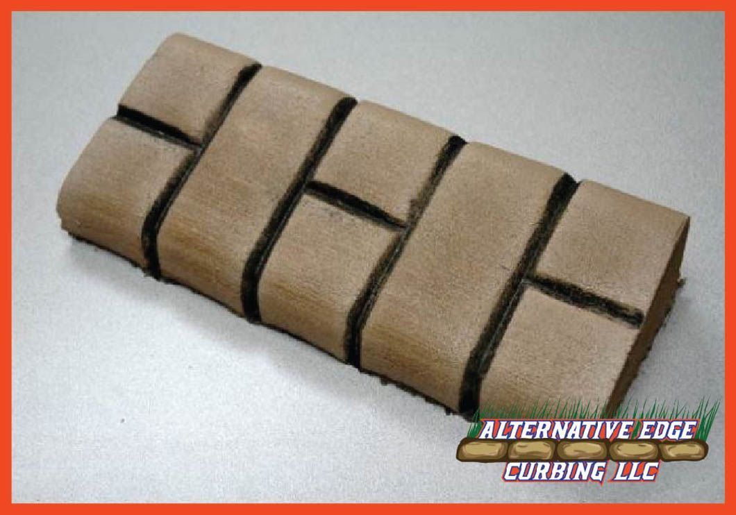 Tan-colored brick pattern, with black lines outlining bricks on a rectangular surface.